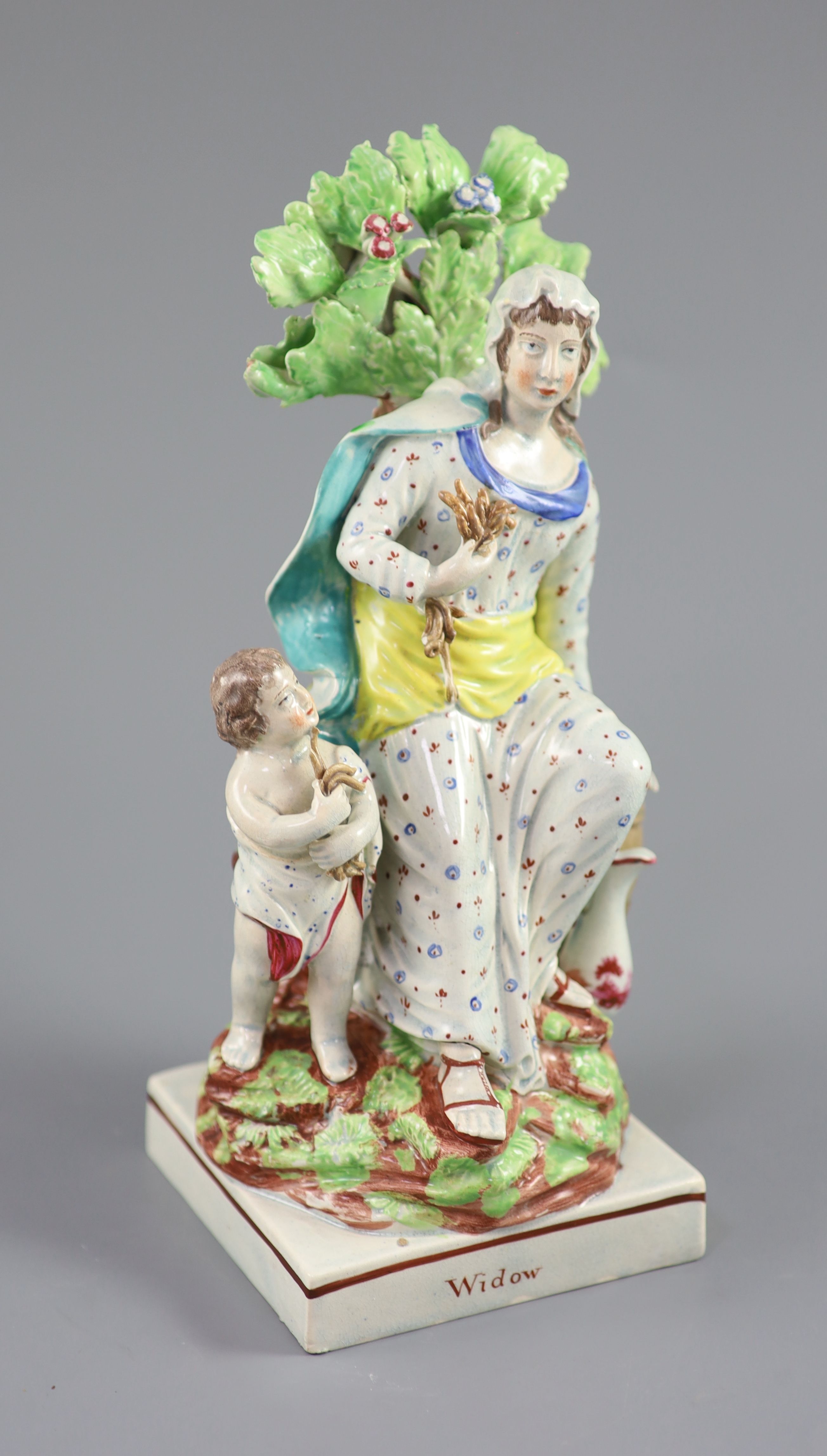 A Ralph Wood type group of a widow of Zarepeth with oil and barrel, c.1790-1810, 27.5cm high